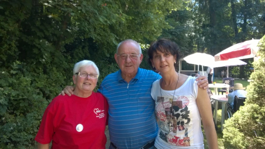 the man and two women are posing for the camera