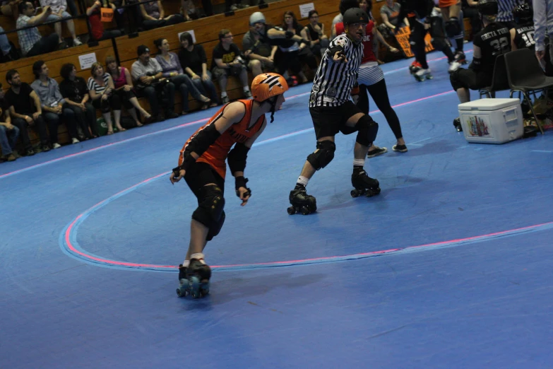 two young men wearing roller skates during a game