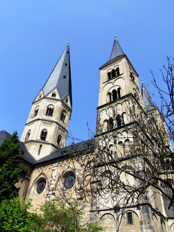 two tall stone buildings with pointy tops and pointed windows