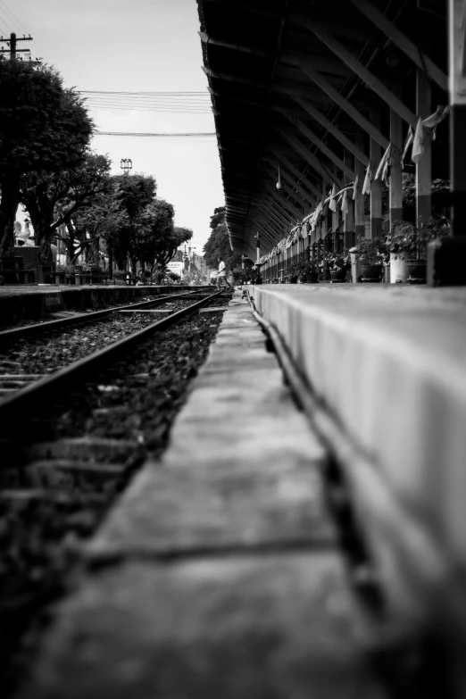 a train station with the tracks running alongside