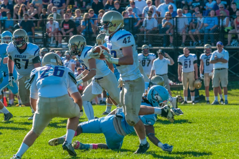 football players in uniforms play on the field