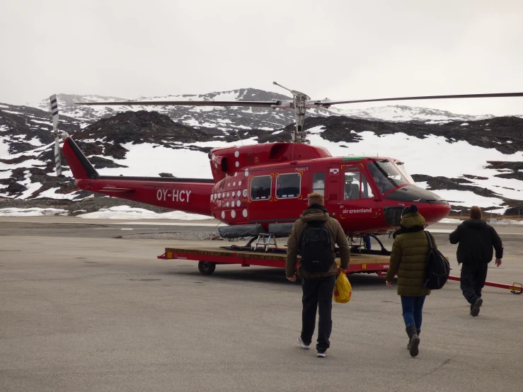 two people are walking toward an air ambulance