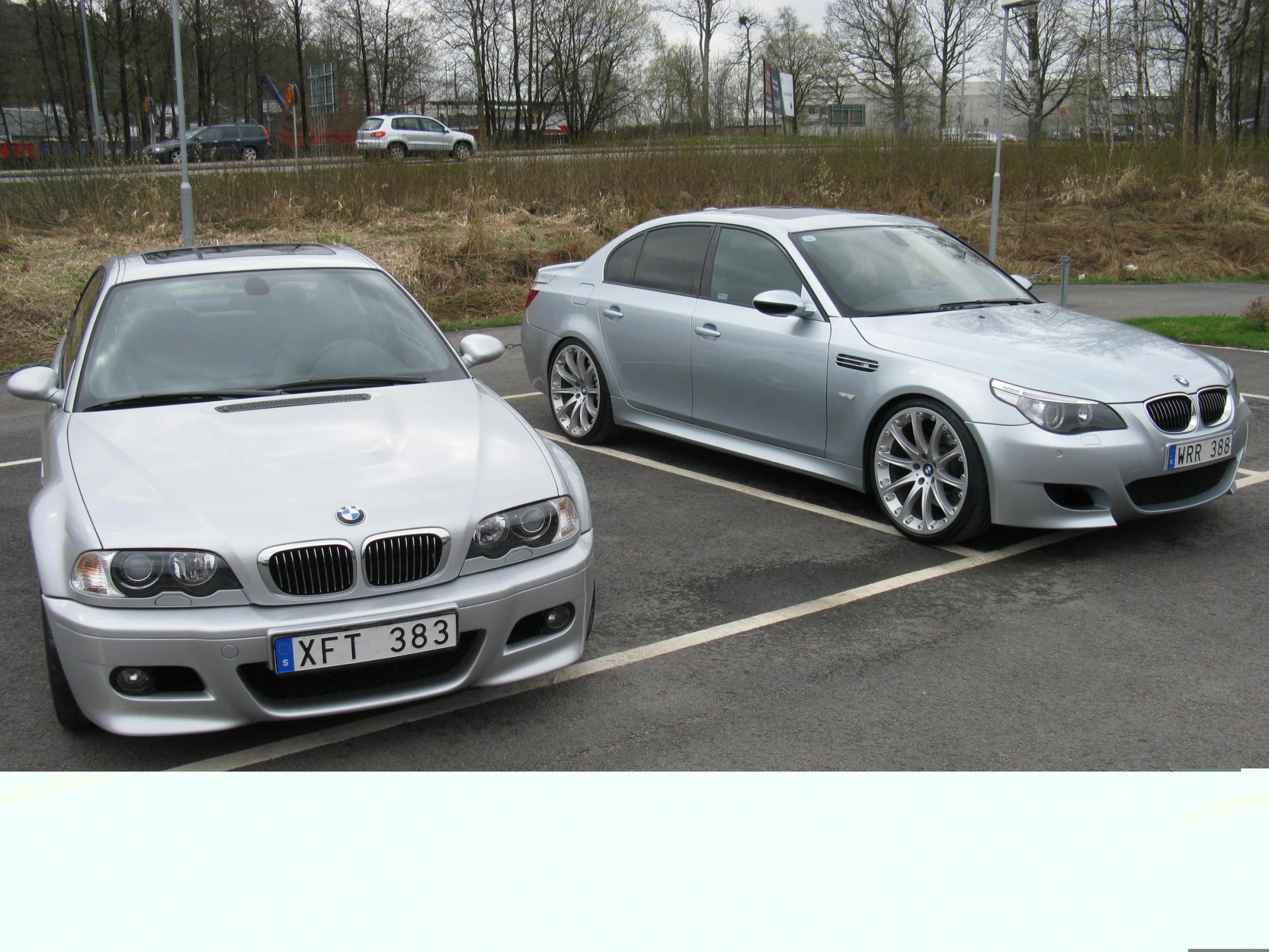 two cars side by side in a parking lot