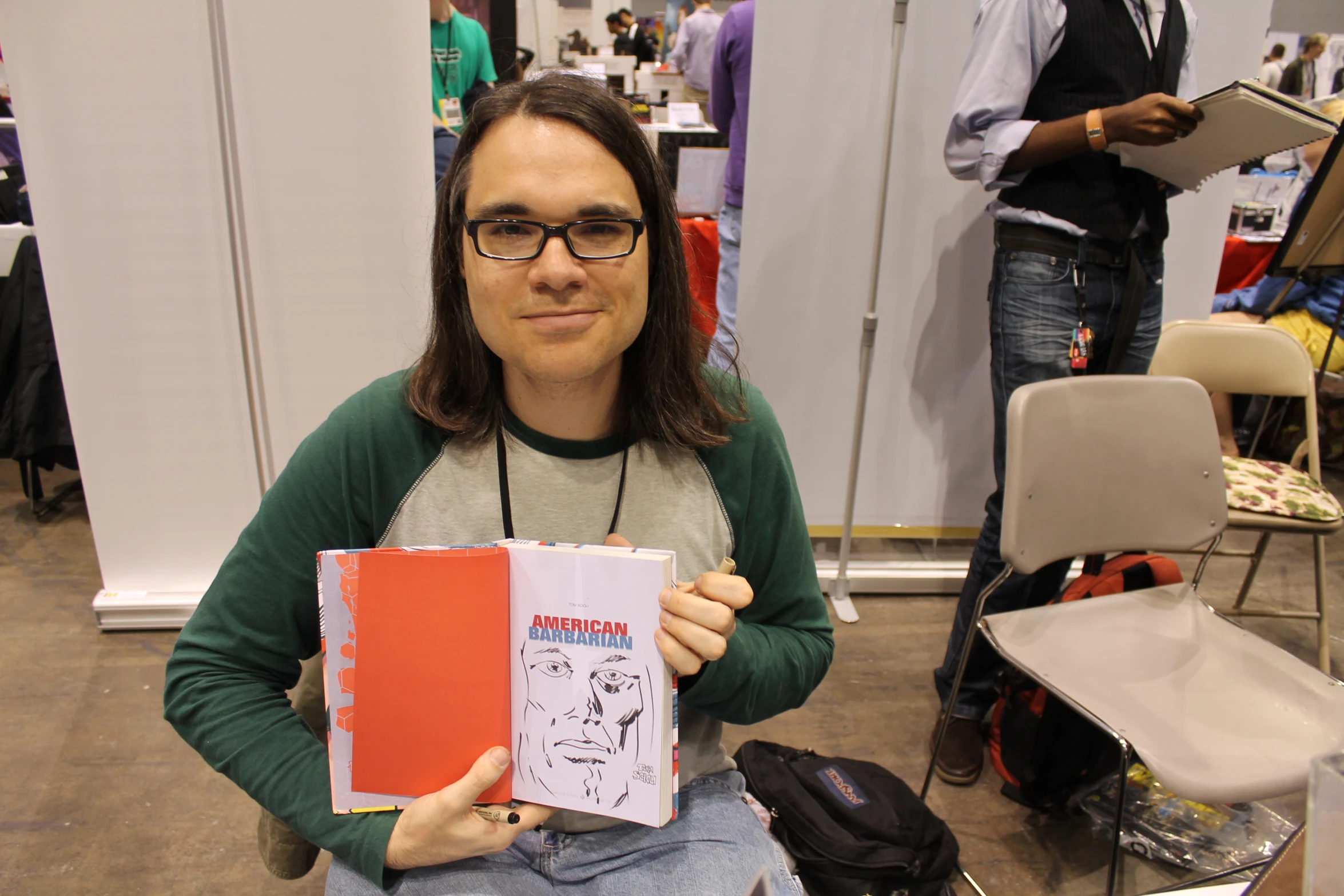 a man holding two large books in his hands