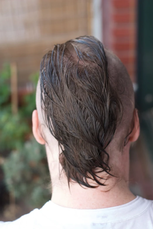 a man that is outside with soing in his hair