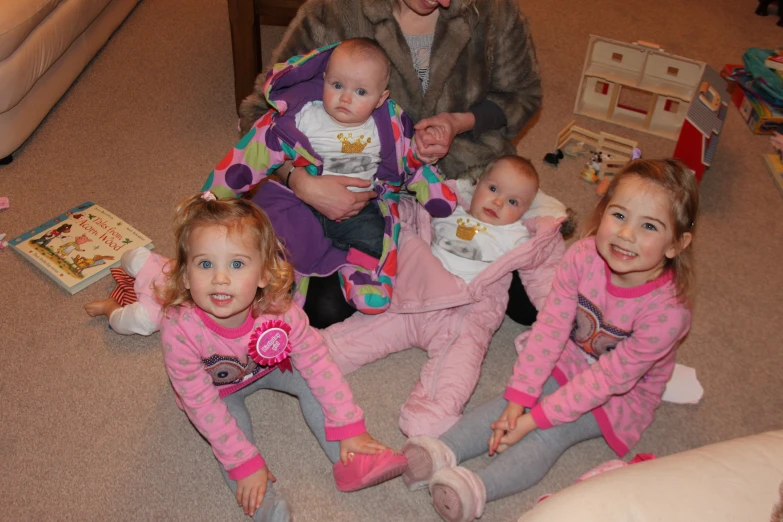 a man is holding several baby dolls in his hands