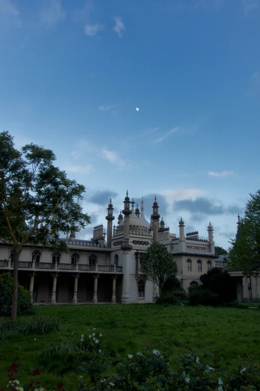 a large building with a clock on it's side and a park area