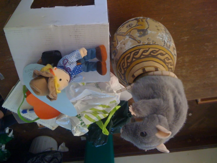 a stuffed animal sitting next to a toy elephant