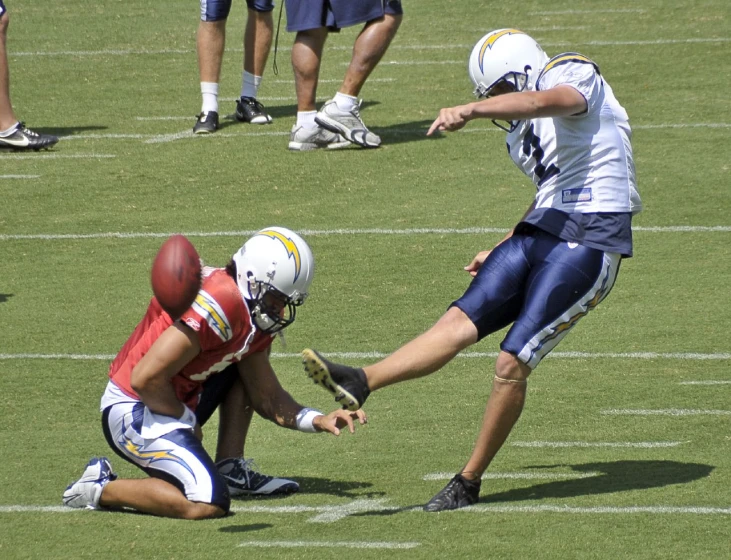 several football players are playing in the middle of the field