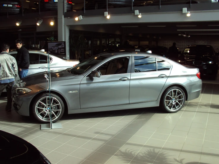 a silver car is on display at the showroom