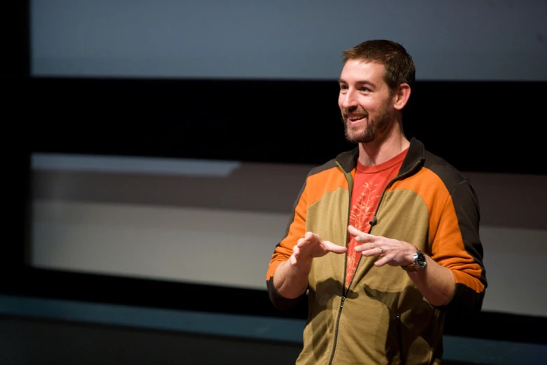 a man is giving a presentation to someone on stage