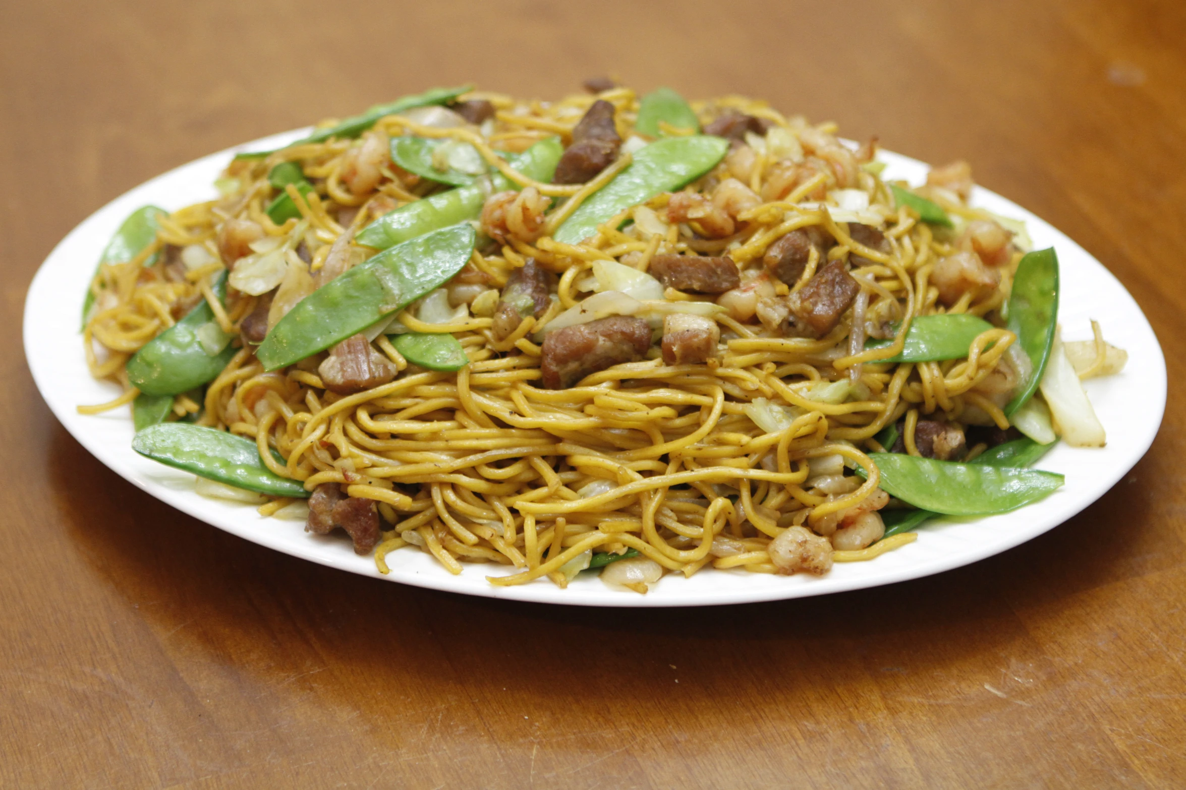 noodles with snap peas and ground meat in the middle