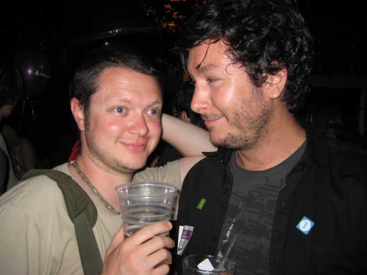 a couple of men that are holding a glass