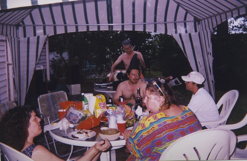 a group of men and women sitting at a table