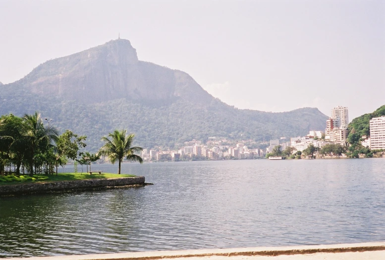 a mountain view overlooking the water from a beach