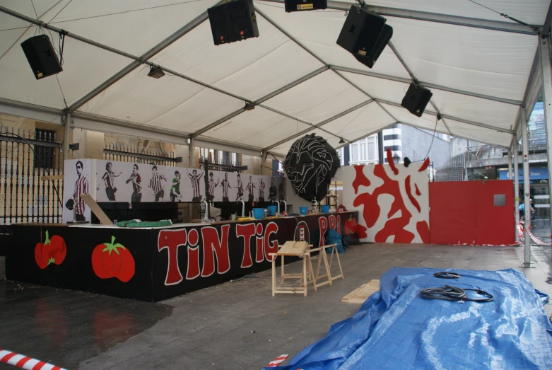 a tent with chairs and a bar that has several chairs