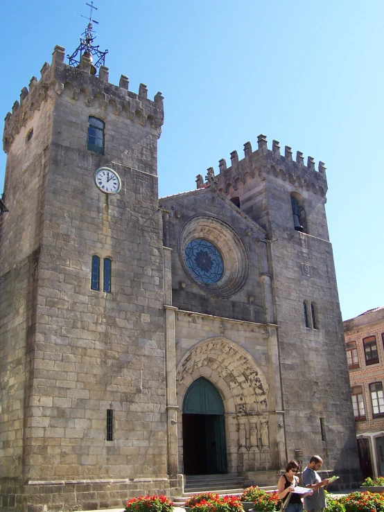 there are two people that are outside in front of a castle