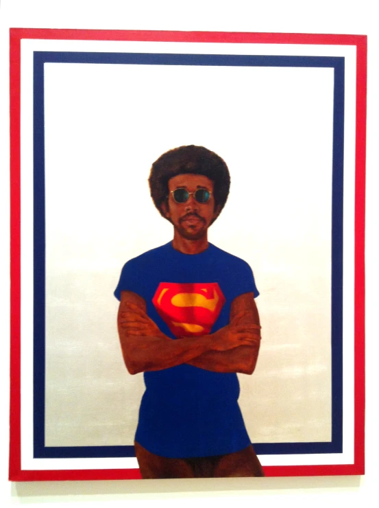 a portrait of a man with glasses and superman shirt
