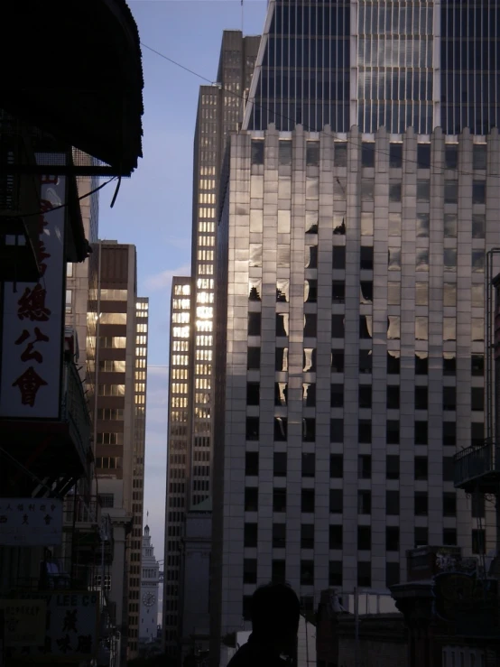 people walking in the city with tall buildings