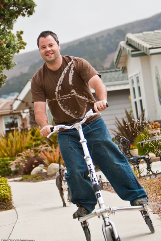 a man is riding his bike in a driveway