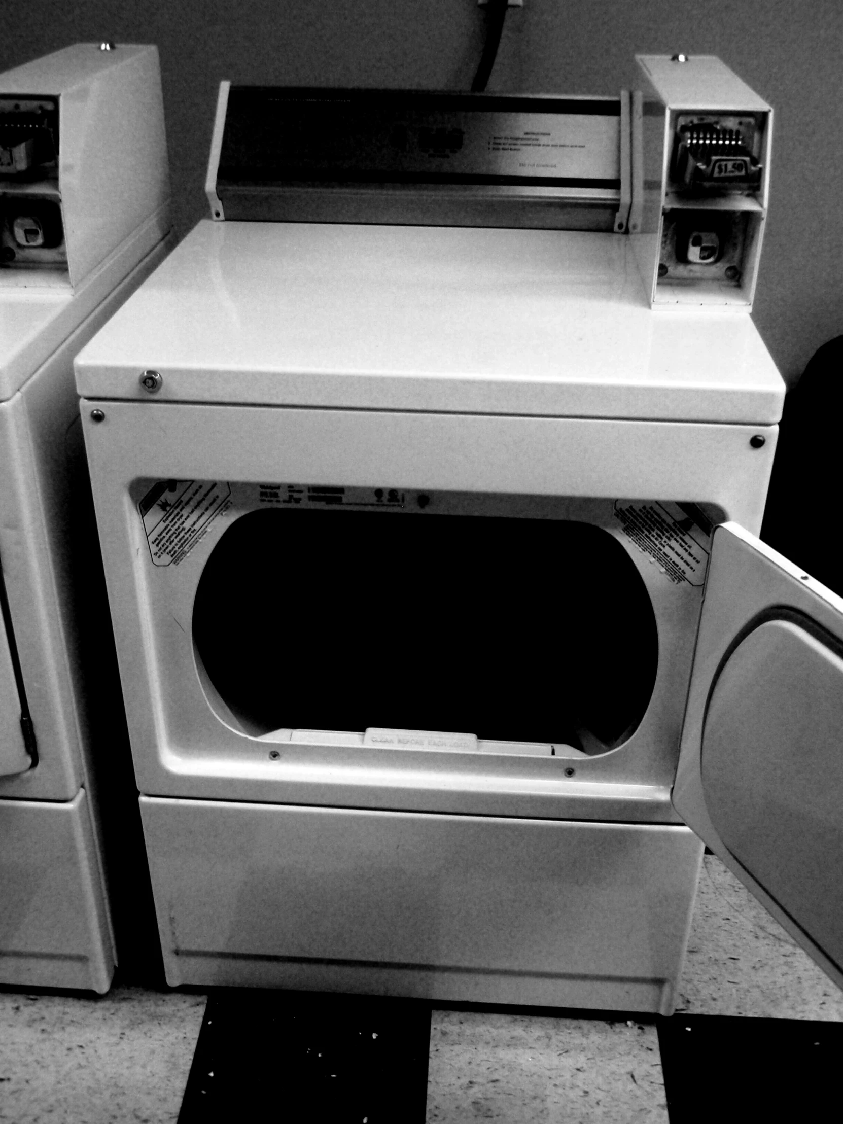 the black and white image shows a stack of appliances