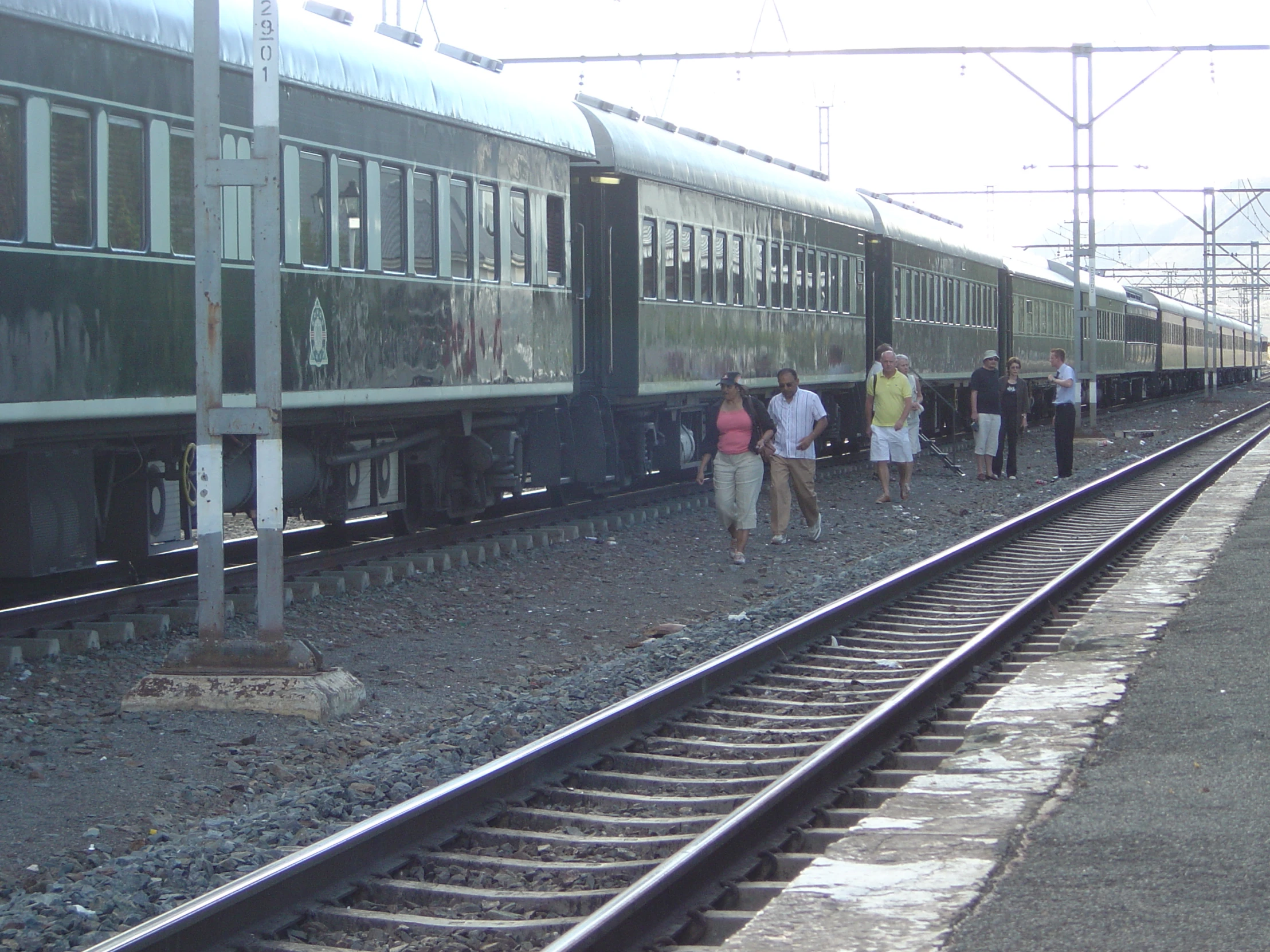 people are waiting for the train to stop on the tracks