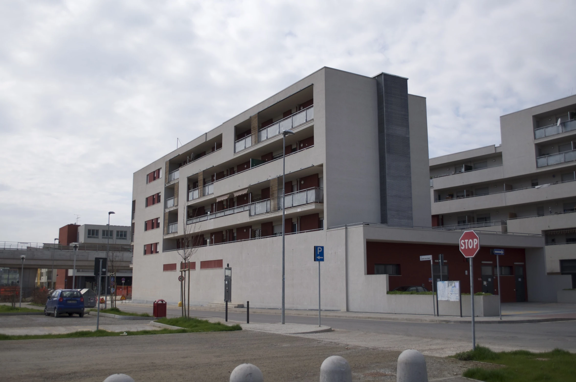 an empty parking lot next to a building with balconies