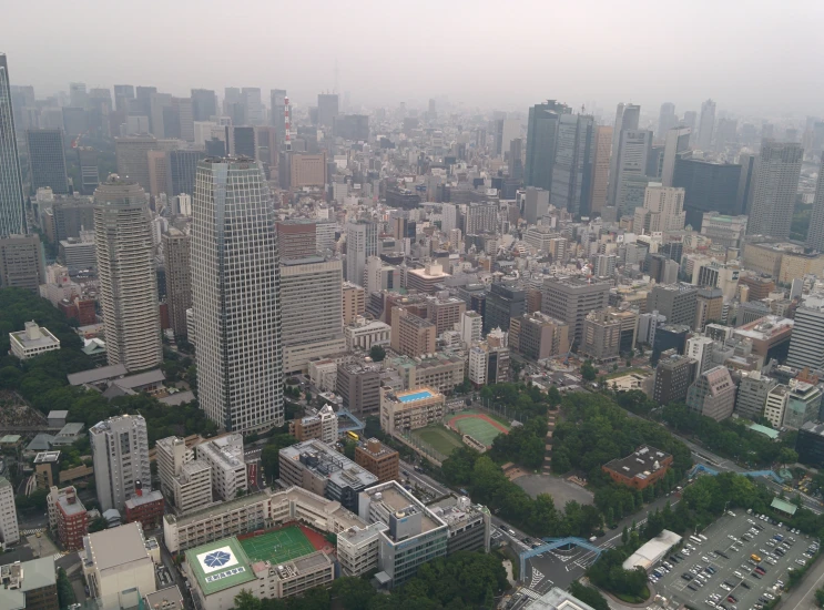 an aerial view of city buildings and a baseball field