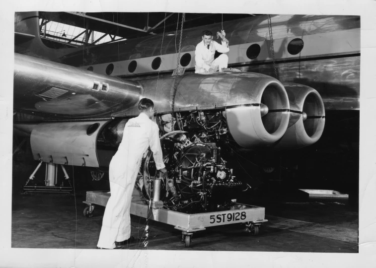 black and white po of pilots at the controls of a small plane