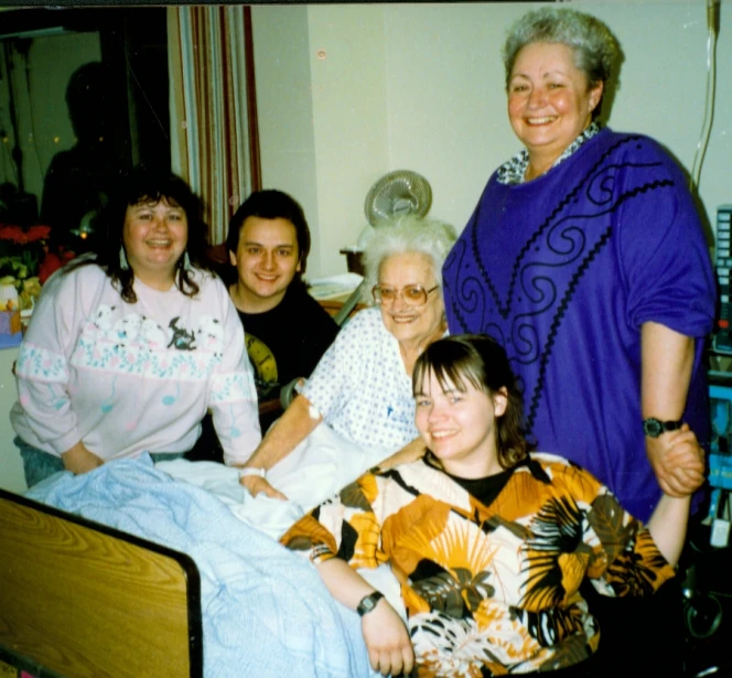 five women and two children posing for a po