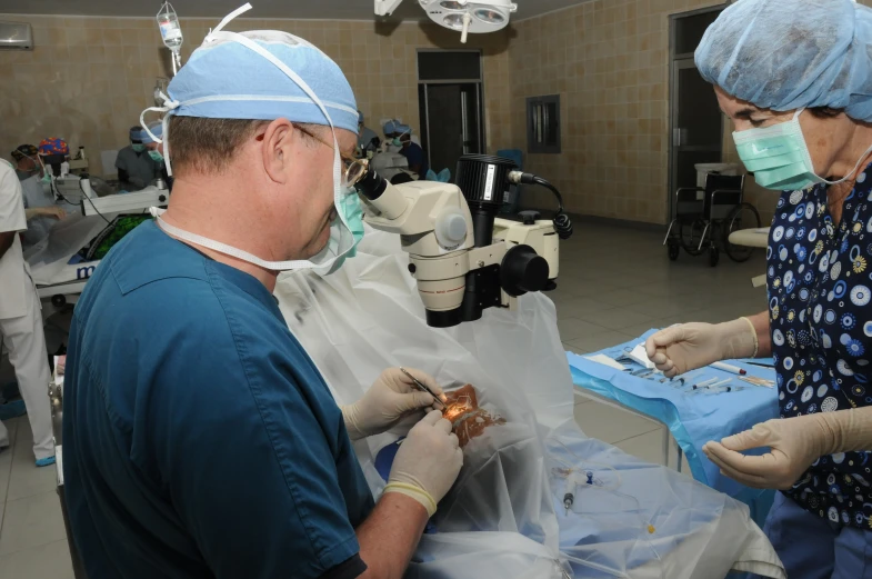 two surgeons are doing  and preparing for someone