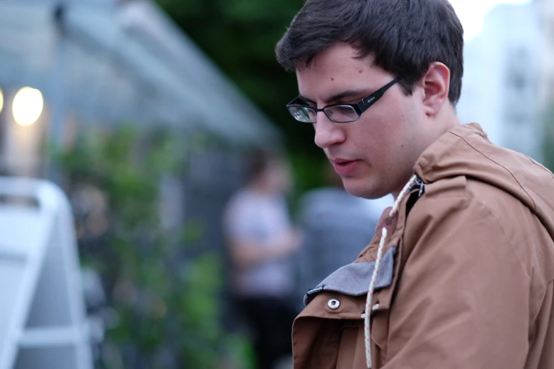 a young man looking at a smart phone