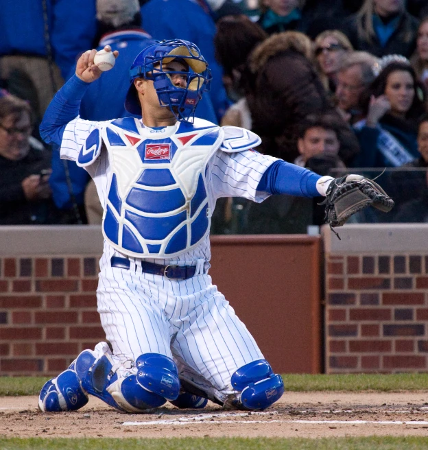 a man with a baseball uniform sitting on the ground