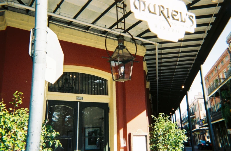 the entrance to a building with hanging light fixtures