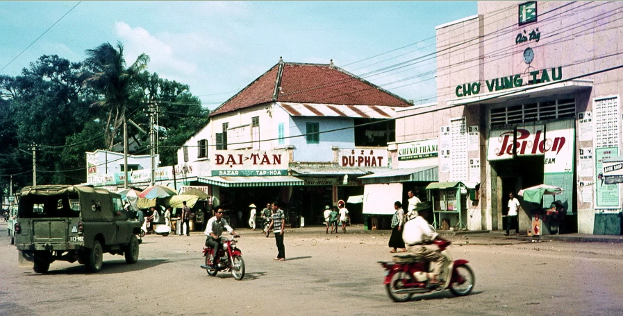 the military vehicle is approaching a few pedestrians