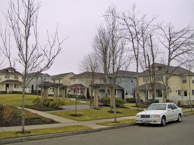 a few cars parked next to houses on a street