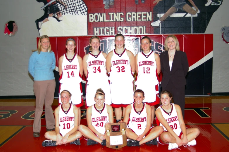 the team with coaches and staff posing for a po