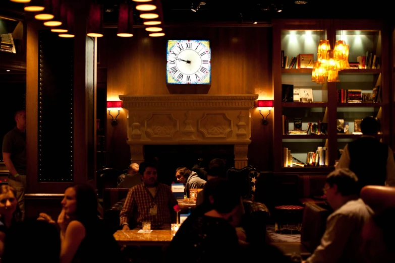 a group of people in a room with a clock on the wall