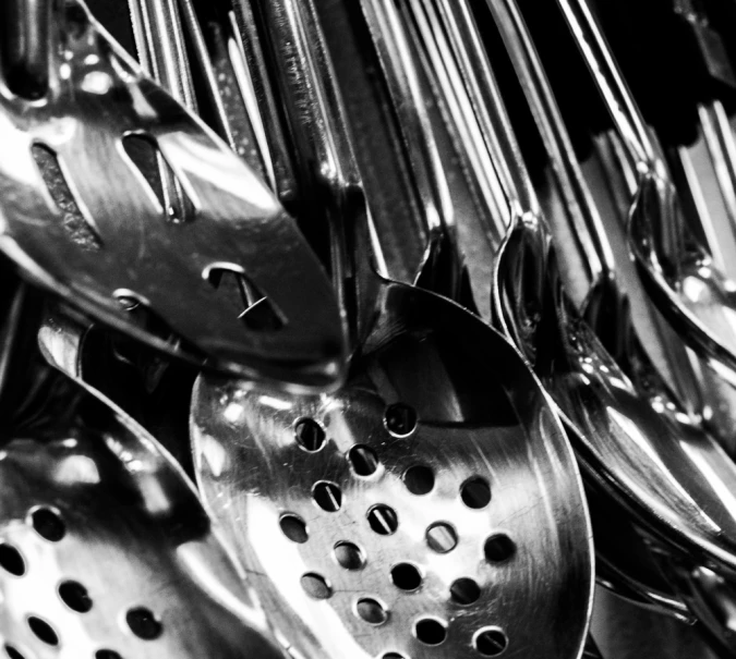 a pile of different spoons are stacked on top of each other