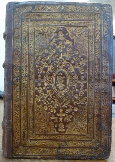 an antique book sitting on a table in a liry