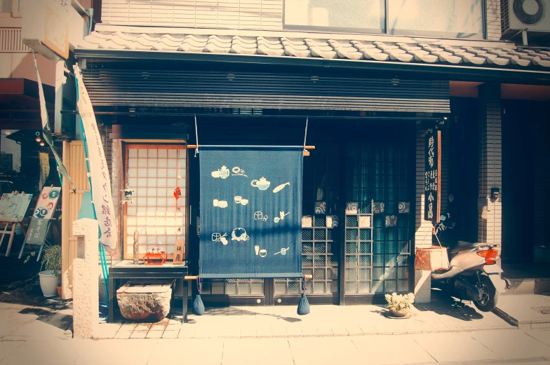 a blue and white gate with two motorcycles sitting outside it