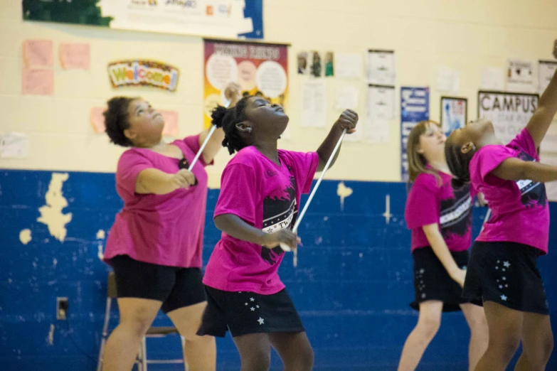 several children are on the court playing basketball