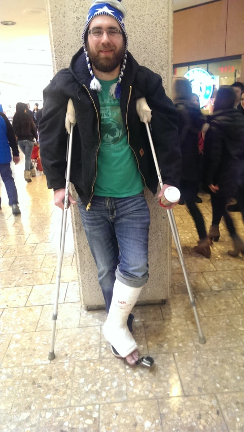 a man walking with his legs in crutches