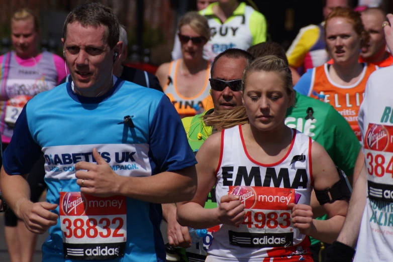 runners in a marathon make their way down the street