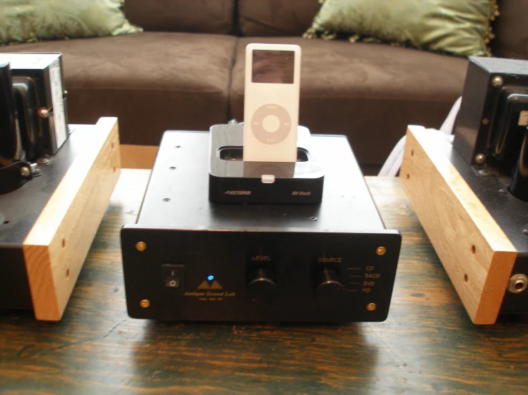 ipod speakers sitting on top of an entertainment center