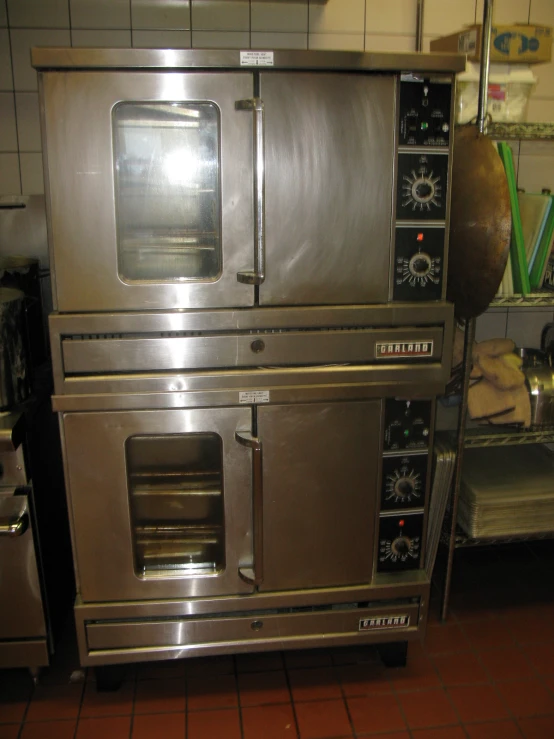 a big stainless steel oven in a large room