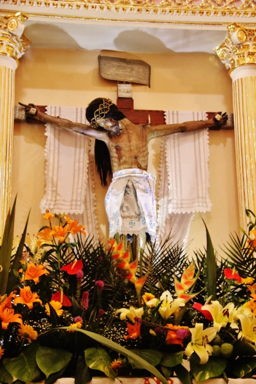 the religious body and cross is adorned with flowers