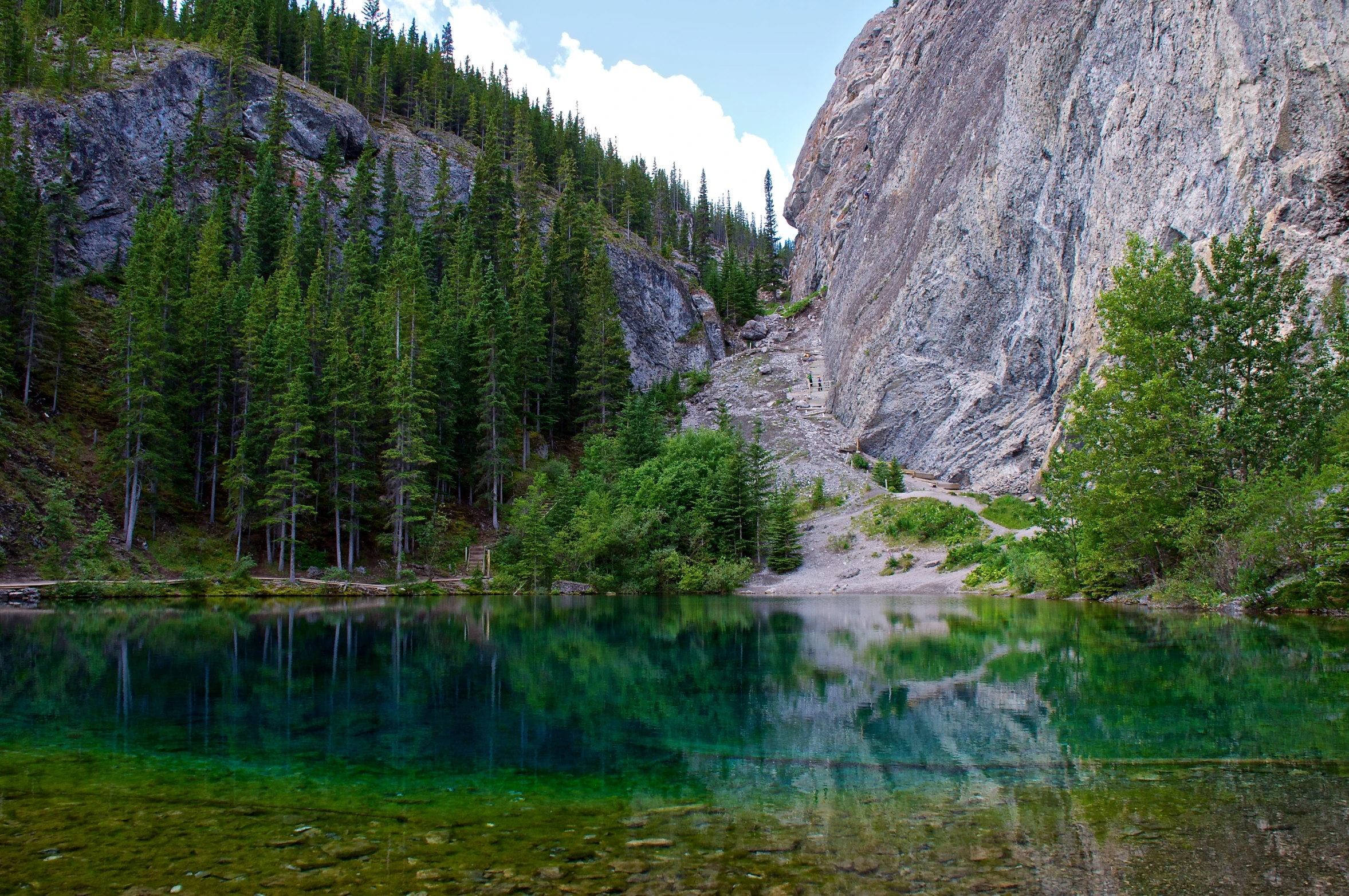 a still lake surrounded by mountains and trees