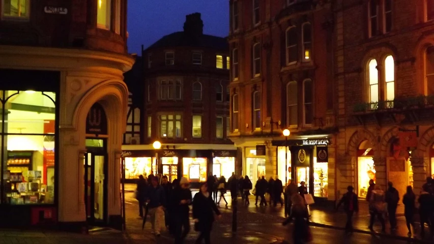 a city with several buildings and people walking around the street