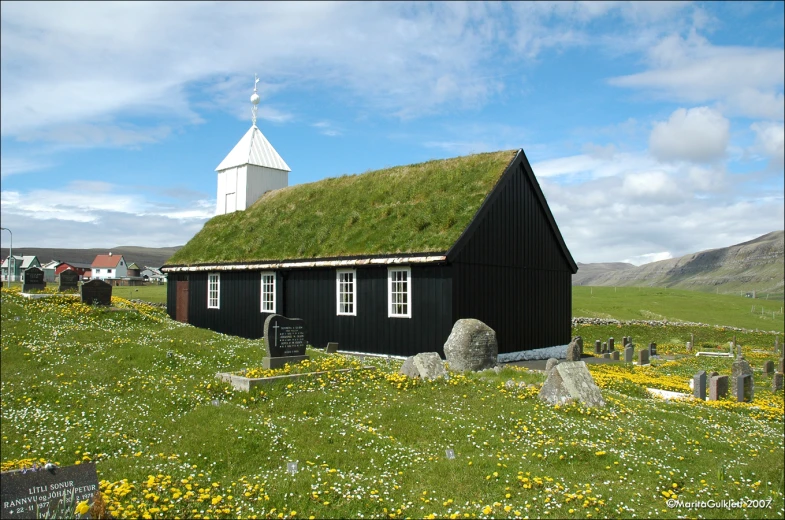 an old black church with a green roof